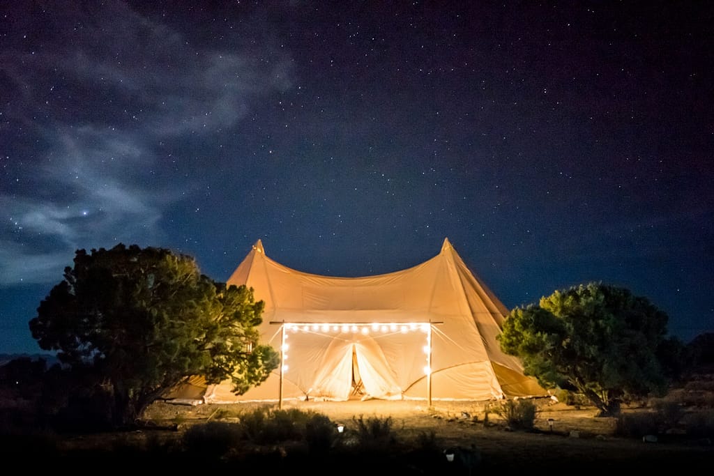 beige tent under starry skies to attend free festivals uk 