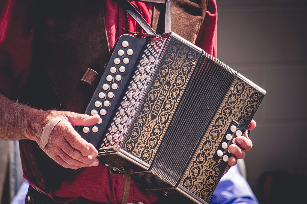 person carrying accordion to play at free music festivals uk 