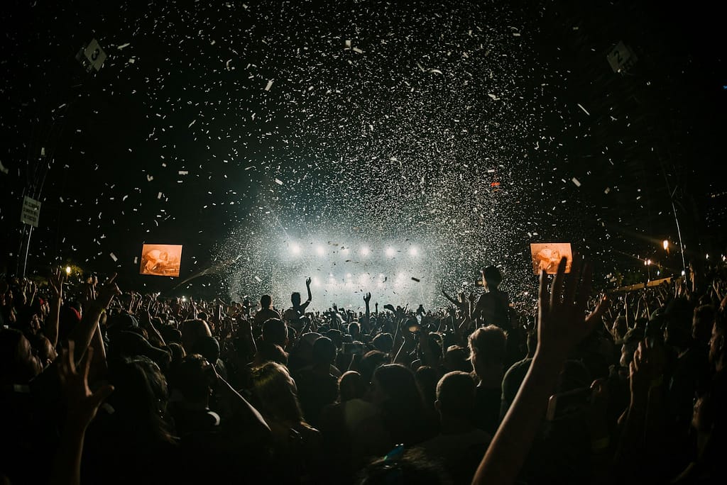 people gathering on concert field UK vs US festivals 
